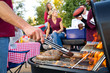 Tailgating: Bratwurst or Sausage On The Grill At Tailgate Party