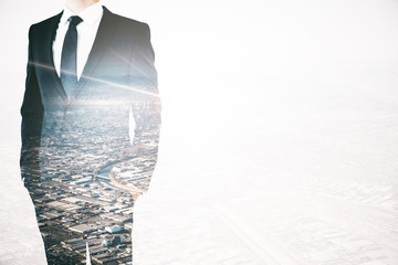 Wall Mural - Businessman on city background multiexposure