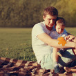 © guas - Portrait happy father and son child together resting outdoors on