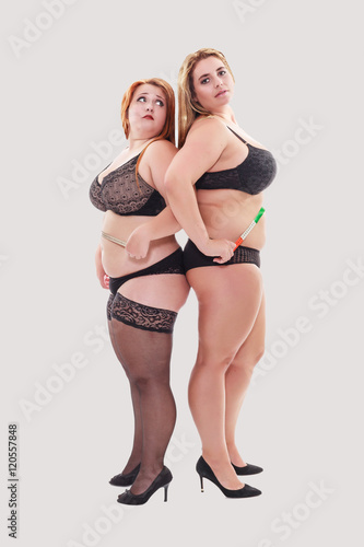 Two Young Chubby Women In Lingerie Standing Behind The Other And