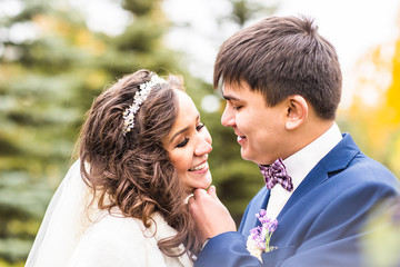 Wall Mural - Happy sensual handsome groom and bride hugging close-up