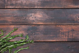 Fototapeta Dziecięca - Bunch of rosemary on wooden table, rustic style, fresh organic herbs, top view