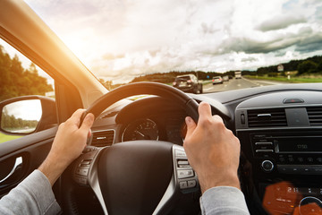 Man driving his car. Bright light effect