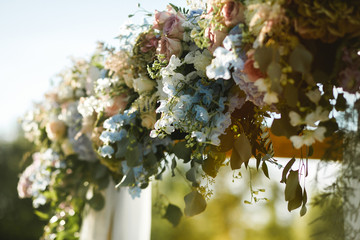 Wall Mural - luxury wedding arch with lush leaves, delicate roses and purple hydrangea outdoors. wedding floristr