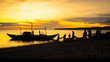 Fishermen dragging fishing net from boat to beach - Sunset silhouette in Aklan, Panay - Philippines