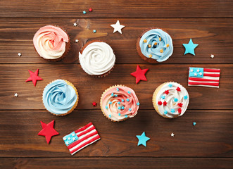 Wall Mural - Delicious cupcakes on wooden background