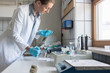© Kzenon Premium - Laboratory technician woman in sewage treatment plant analyzing water sample