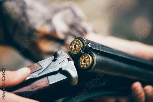 Cuadros en Lienzo Male hunter in the autumn forest. A man holding a gun.