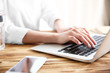 © Africa Studio - Woman working on computer at wooden desk