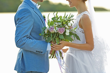 Canvas Print - Happy wedding couple on river background