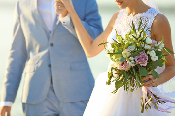 Wall Mural - Happy wedding couple on river background