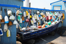Boat And Old Colorful Fishing Buoy Hanging On The Wall For Decoration