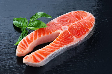 Sticker - Fresh salmon with basil on a dark background