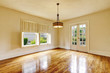 © Iriana Shiyan - Empty room interior in beige tones and shiny hardwood floor.