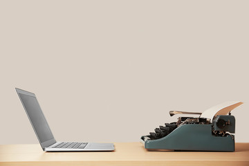 Sticker - Old typewriter and laptop on table. Concept of technology progress