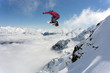 © Vasily Merkushev - Snowboarder jumping in snowy winter mountains