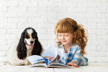 Redhead girl with a puppy cocker spaniel