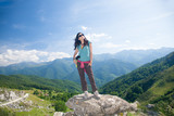 Fototapeta Las - woman thinking on rock in Cantabrian mountain