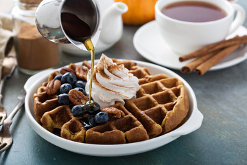 Pumpkin waffles with whipped cream for breakfast