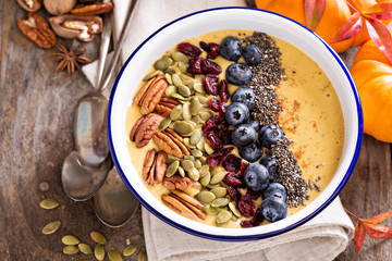 Wall Mural - Pumpkin smoothie bowl with nuts and seeds