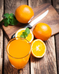 Wall Mural - fresh fruits orange juice in glass on wood