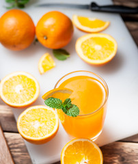 Wall Mural - fresh fruits orange juice in glass on wood