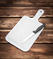 Wall Mural - Cutting board and kitchen knife on wood background