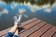 © kieferpix - Young girls feet relaxing by a lake.