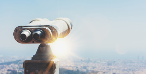 touristic telescope look at the city with view of barcelona spain, close up old metal binoculars on 