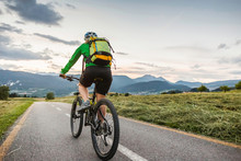 Woman Cycling On Road, Fondo, Trentino, Italy