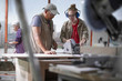 © Connect Images - Female trainee carpenter learning to use power saw in furniture making workshop
