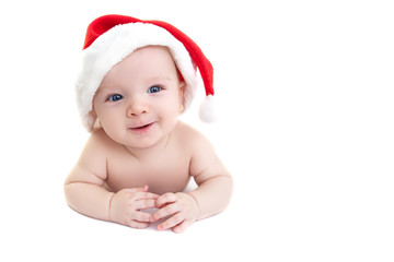 Christmas cute baby boy or girl lying on white like on snowdrift, beautiful funny infant in Santa's hat