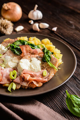 Wall Mural - Roasted pork cutlets with bacon, cheese, spinach and potatoes