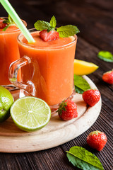 Wall Mural - Energizing smoothie with mango, strawberries and lime in a glass jar