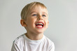 cheerful laughing boy showing healthy teeth, the child expresses