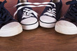 © Christopher Hall - Old canvas shoes on a wooden floor