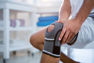 mid section of man with knee injury
