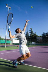 Wall Mural - Professional tennis player man playing on court