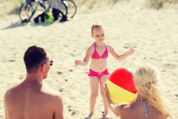 Canvas Print - happy family playing with inflatable ball on beach