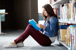© Syda Productions - high school student girl reading book at library