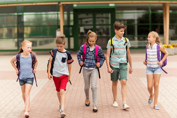 Canvas Print - group of happy elementary school students walking