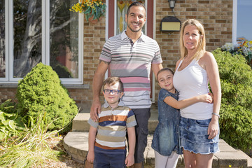 Wall Mural - Portrait of happy family in front  house