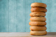 High Bagel Stack on Wood with Turquoise Blue Background