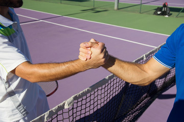 Close up of two professional tennis players shaking hands at a tennis match