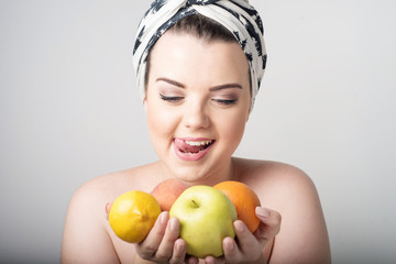 girl holding apples and oranges