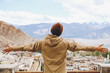 © twinsterphoto - Happy young traveler spreading arms in city background in Leh, Ladakh, India