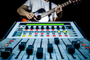 Wall Mural - guitarist & recording mixer in studio, isolated on black for music background