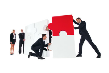 Wall Mural - Business people assembling puzzle