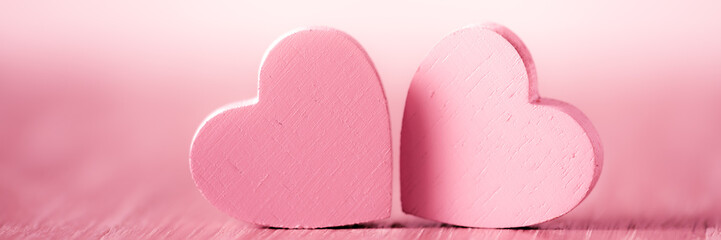 Wall Mural - two pink hearts on a pink background