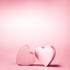Wall Mural - two pink hearts on a pink background